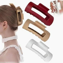 Set of hair clips in red, beige, and white on a white background