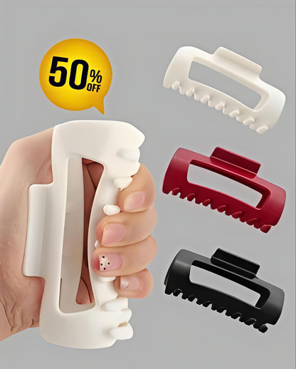 Hair clip with a hand holding it, surrounded by additional clips on a gray background with a 50% off label.